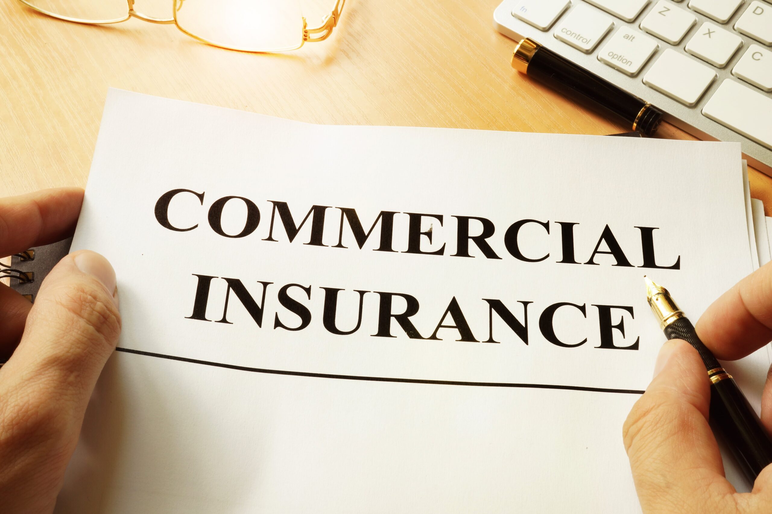 A work folder with writing saying Commercial Insurance